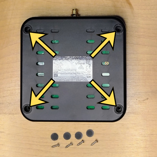 SyncroBit base — peel off the 4 corner rubber pads and remove the 4 Phillips screws