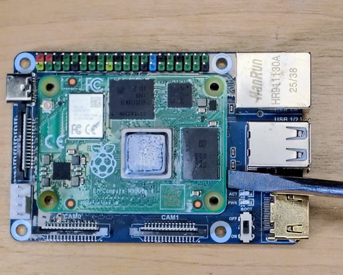 Gently pry the Compute Module 4 off the CM4 IO board with a flathead screwdriver